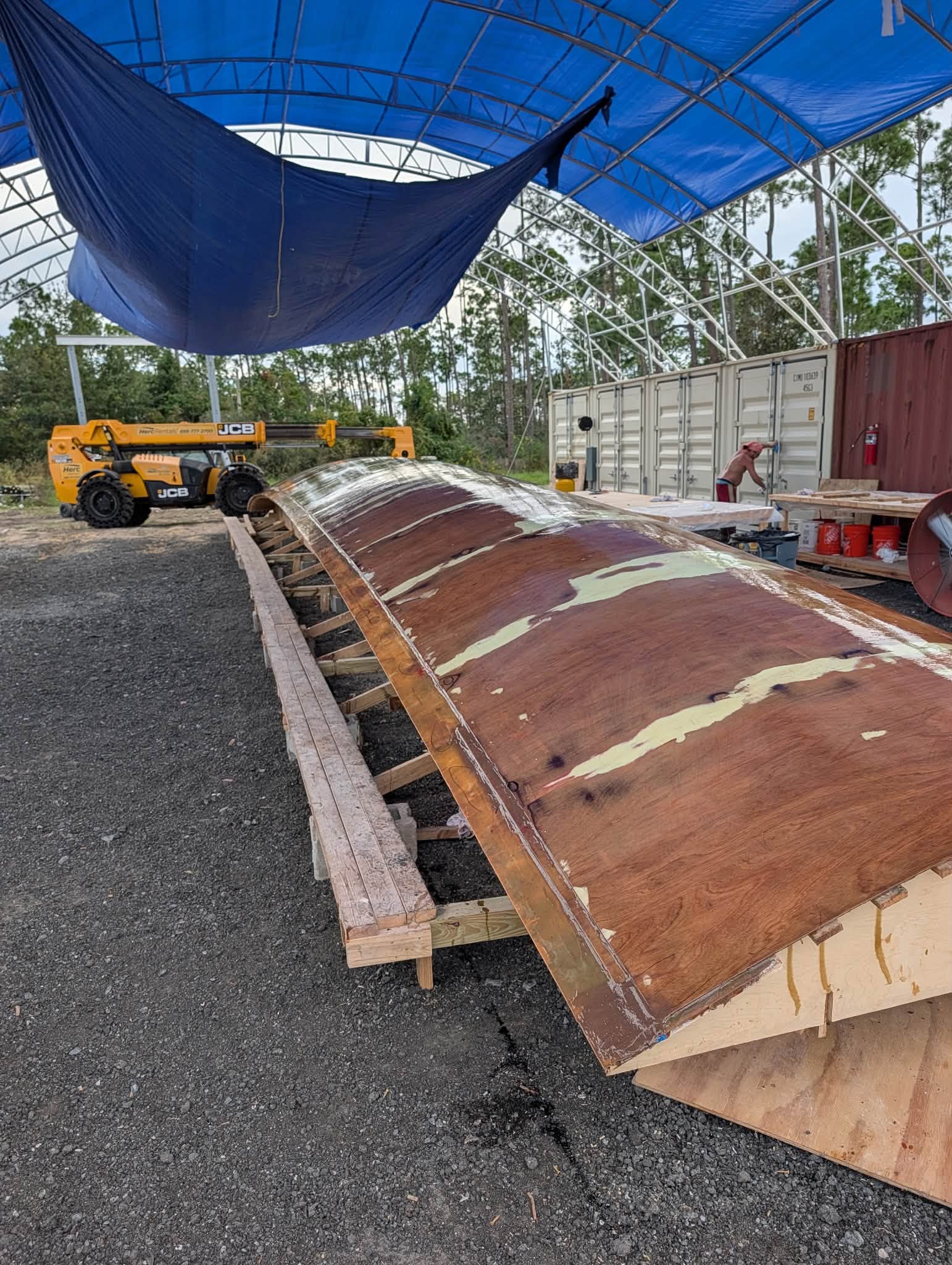 Looking down the length of the finished hull mold under the tent